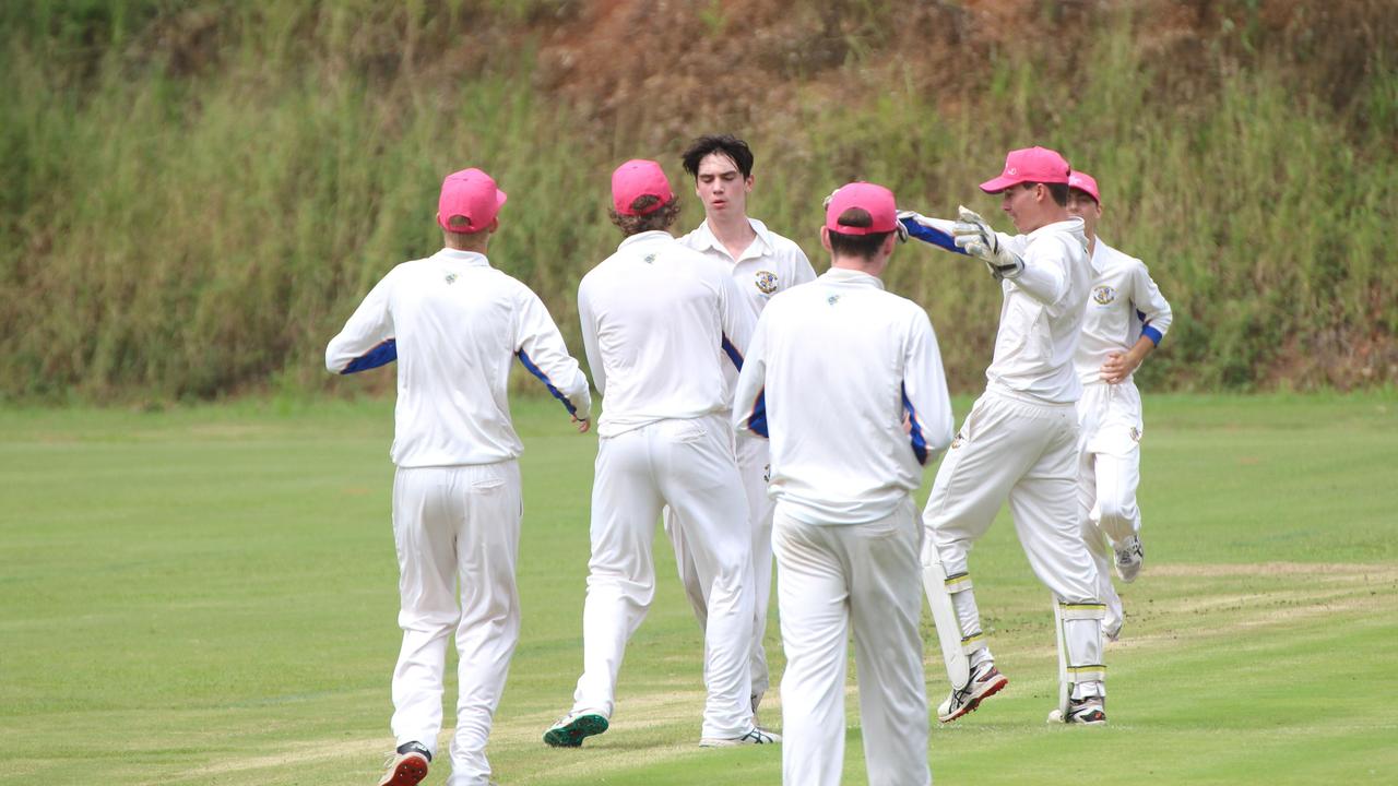 Joey Laner congratulated by teammates after snaring a wicket.