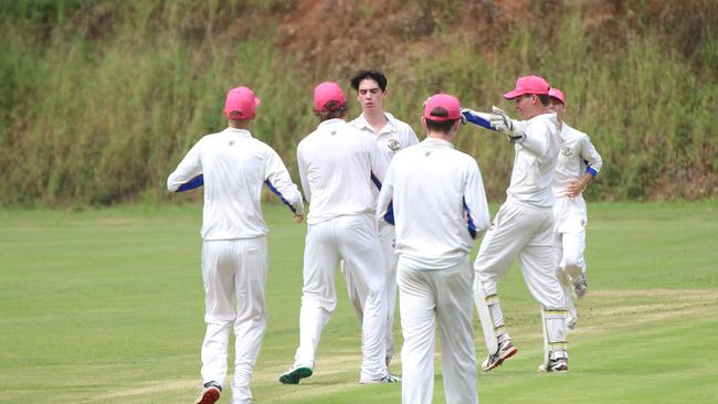 Joey Laner congratulated by teammates after snaring a wicket.