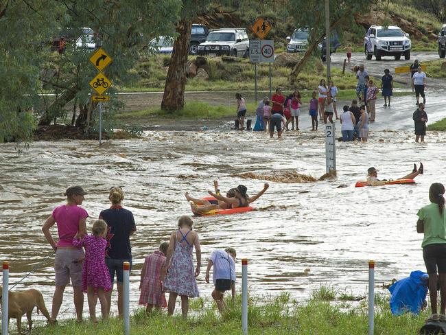 Locals take advantage of the Todd River flow at the Schwartz Crescent causeway. PHOTO: Barry Skipsey