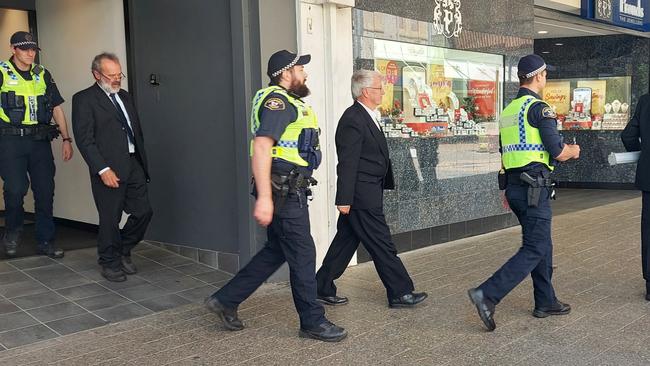 The arrest at NAB Launceston on December 7, 2022 of Extinction Rebellion protesters Graham Bailey (left), Pr Jeff McKinnon (centre) and Dr Scott Bell (right). Picture: XRNT