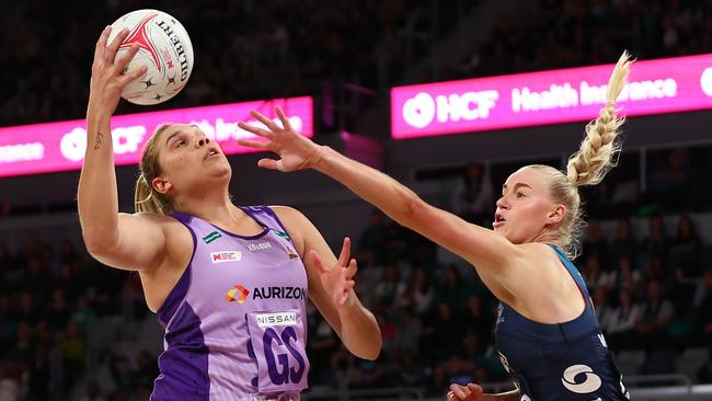 Donnell Wallam of the Firebirds (L) catches the ball under pressure from Jo Weston.