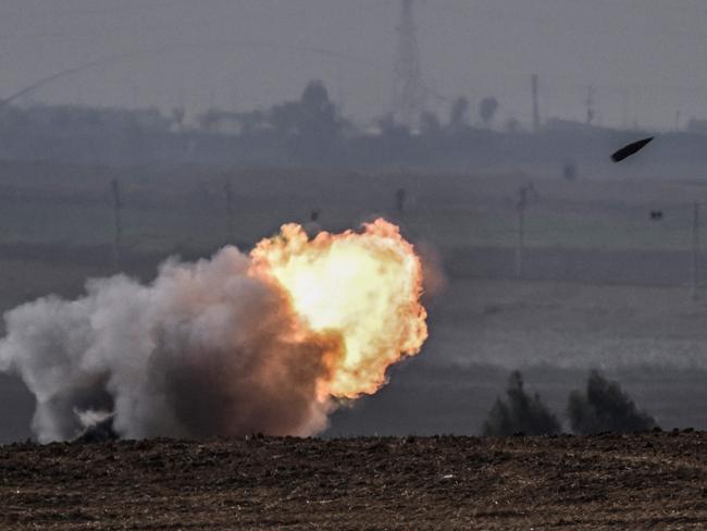 The Israeli military fires shells toward the Gaza Strip on October 28, 2023. (Photo by Arts MESSINIS / AFP)