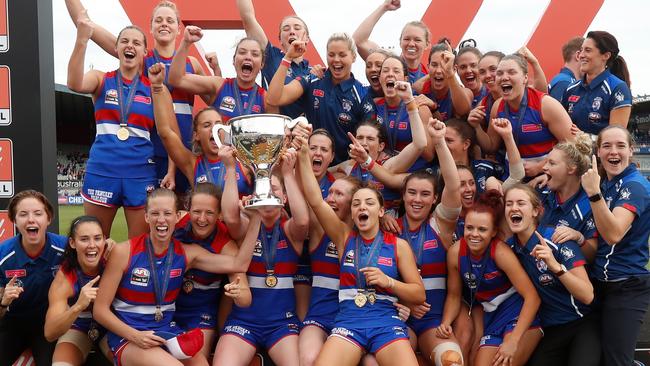 Western Bulldogs players celebrate with the premiership cup.