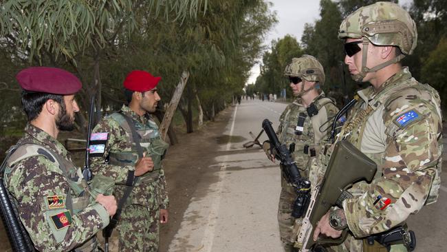 AFGHANISTAN .. Australian Army soldiers ‘Guardian Angels’ Private Jake Britten (far right) and Lance Corporal Brian Amber (right) talk with Afghan National Army soldiers at Camp Hero, during their deployment to Operation Highroad as part of the NATO-led Resolute Support mission in Afghanistan. *** Local Caption *** There are approximately 20 Australian Defence Force personnel providing training and advisory support as mentors at Camp Hero, Kandahar. Australian troops are also deployed to Afghanistan as part of Operation Highroad to provide force protection and security to Australian and Coalition mentors and advisers supporting the NATO-led Resolute Support mission. The force protection elements act in a variety of ways such as close support ‘Guardian Angels’ as well as in more traditional protection roles. The risk of insider threat remains a key consideration for ADF members operating in Afghanistan. There are force protection elements located in Kandahar, Kabul and Qargha. Members of the force protection element are currently drawn from B Company, First Battalion, Royal Australian Regiment, based in Townsville. There are approximately 400 Australian Defence Force personnel deployed across Afghanistan in a variety of roles as part of Operation Highroad contributing to Resolute Support. Resolute Support is focused on training, advising and assisting the Afghan National Security Forces and Afghan security institutions at the operational, institutional and ministerial levels.