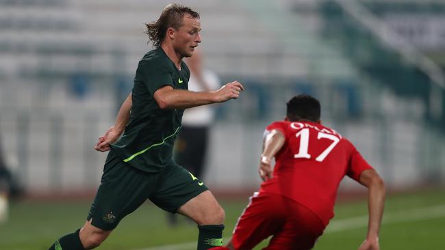 Rhyan Grant rocking the mullet in Australia’s match against Oman on Sunday. Picture: Getty Images 