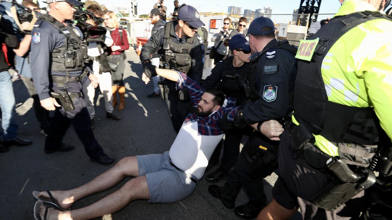 Extinction Rebellion activists are being dragged away by police. Picture: Liam Kidston