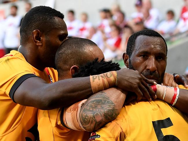 Team-mates celebrate with Garry Lo of Papua New Guinea after he scores a try during the Rugby League World Cup quarter-finals match between Papua New Guinea and England at AAMI park in Melbourne, Sunday, November 19, 2017.(AAP Image/Joe Castro) NO ARCHIVING, EDITORIAL USE ONLY