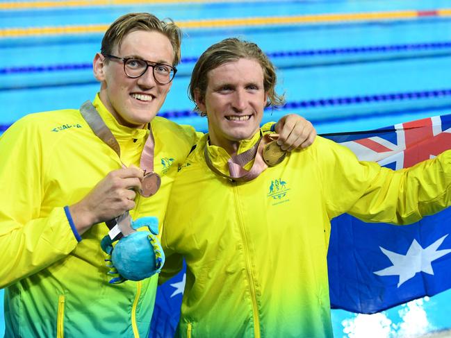 Australia's Jack Mcloughlin (R gold) and Australia's Mack Horton (bronze) pose with their medals after the swimming men's 1500m freestyle final during the 2018 Gold Coast Commonwealth Games at the Optus Aquatic Centre in the Gold Coast on April 10, 2018 / AFP PHOTO / FRANCOIS XAVIER MARIT