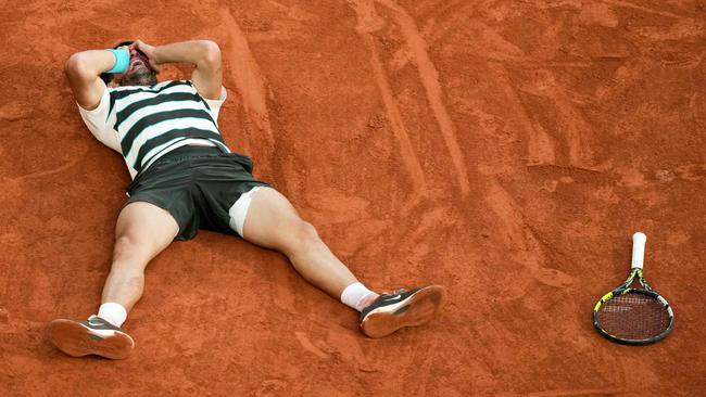 Carlos Alcaraz celebrates after winning match point. (Photo by Dimitar DILKOFF / AFP)