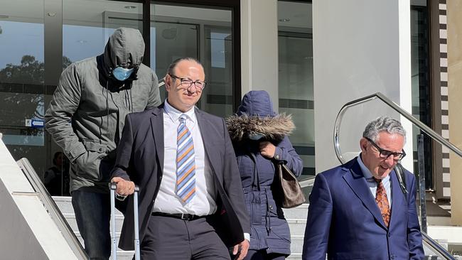 Kais Dahdal (green jacket) leaving Wollongong Courthouse with his legal representatives and his wife (blue jacket). Picture: Dylan Arvela