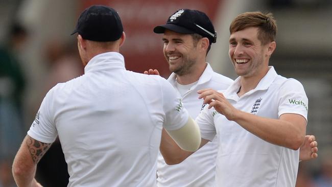 England’s Chris Woakes (R) celebrates with teammates after dismissing Rahat Ali.