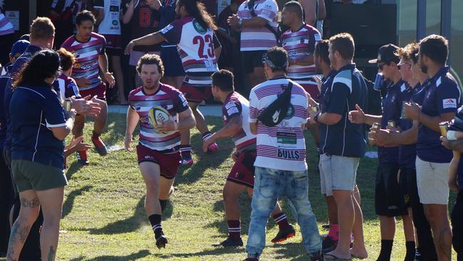 Nerang Bulls captain Josh Edmond leads his team out onto the field. Picture: Adrienne Capie