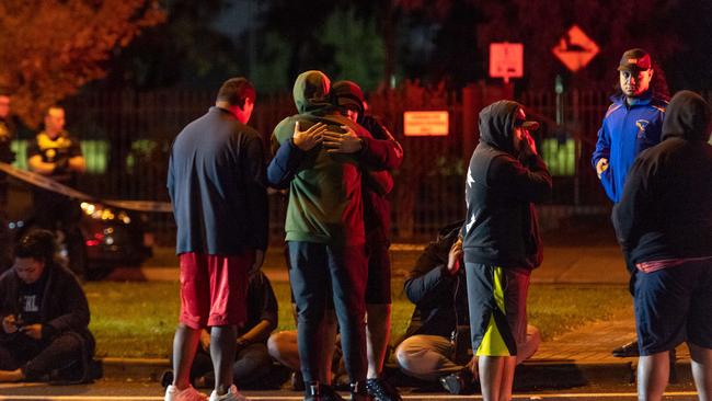 People congregate at the scene of the fatal stabbing. Picture: Jake Nowakowski