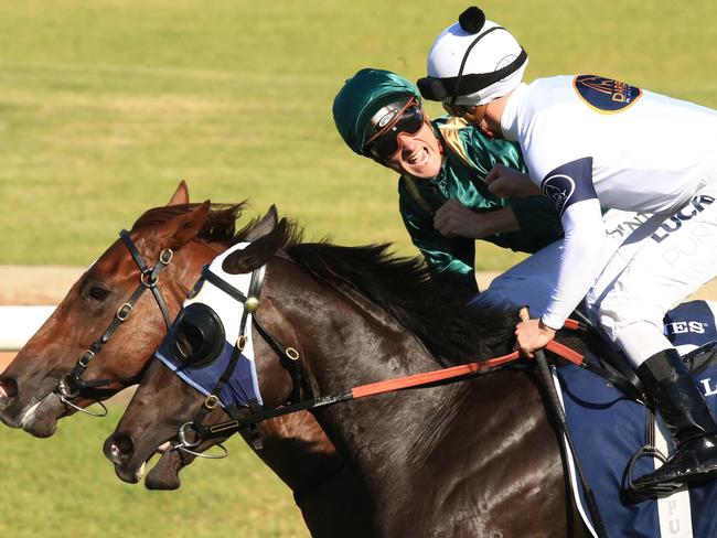 Blake Shinn (Capitalist) is congratulated by Zac Purton (Yankee Rose) after they cross the finish line. Picture: Jenny Evans