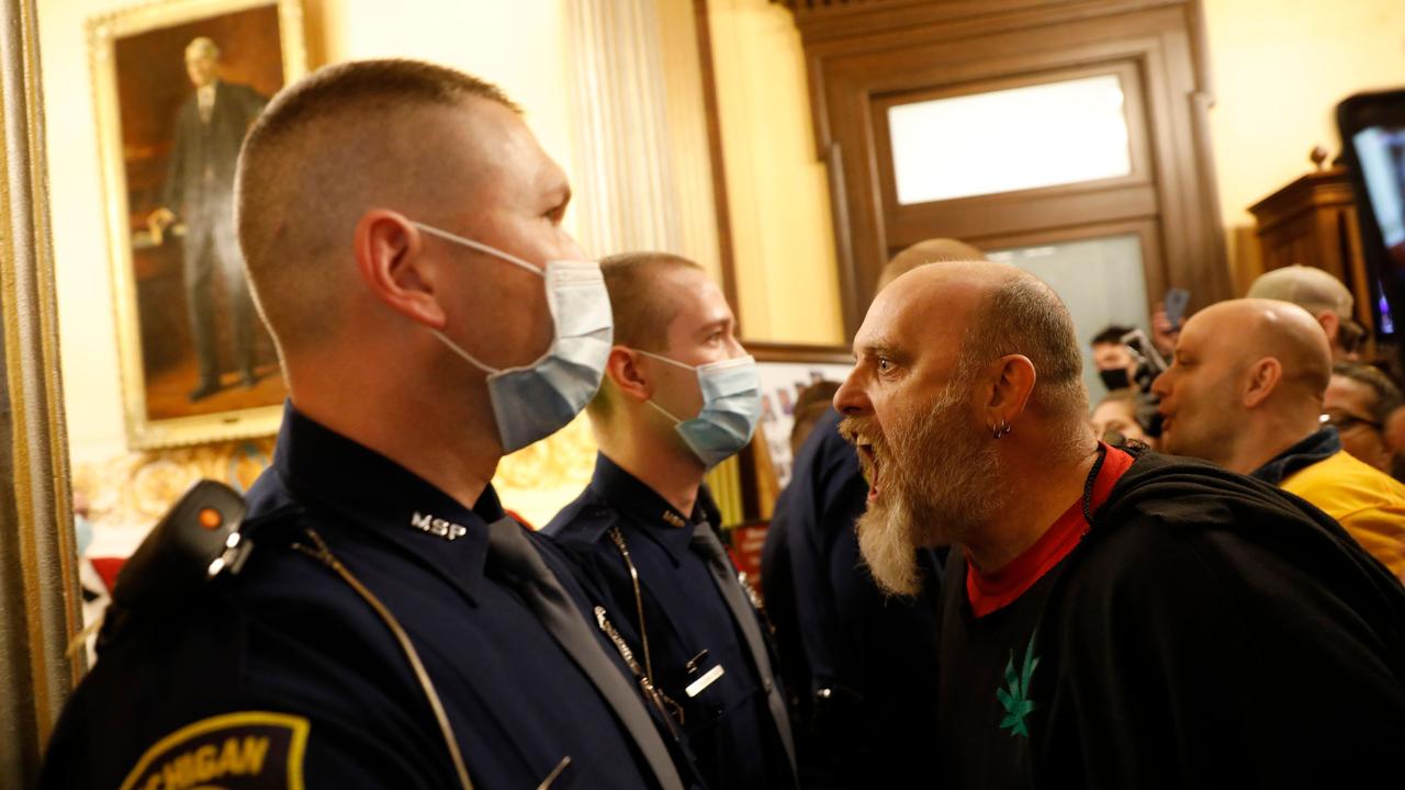 Protestors attempt to enter the Michigan House of Representatives in April, demanding the reopening of businesses. Picture: AFP