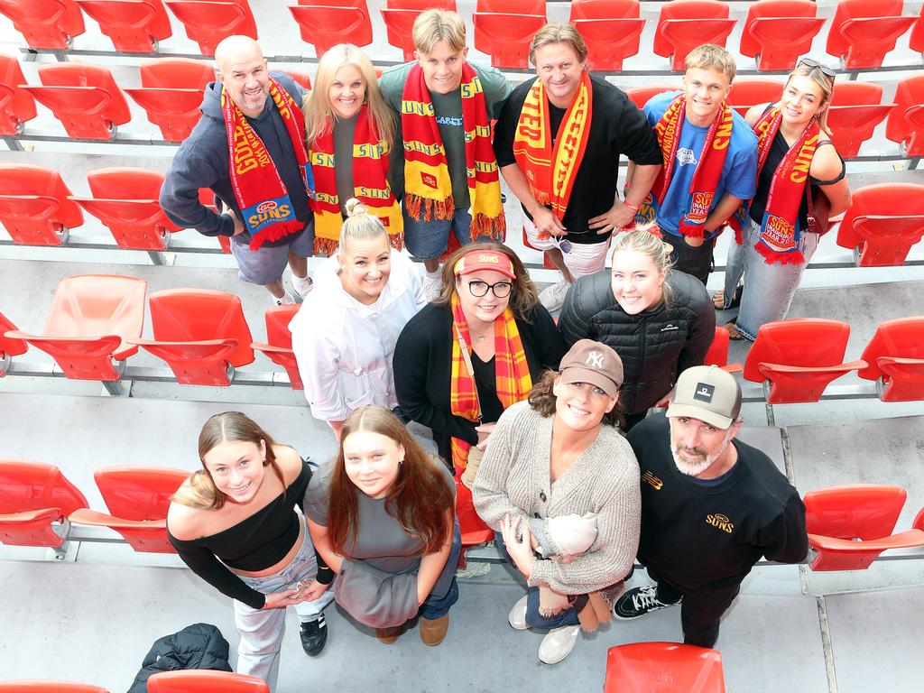 Michelle Uwland (top row, second from left) with sons Mali and Jarrah (top row, far right and currently in the Suns Academy), watching son Zeke at Saturday’s VFL match at People First Stadium alongside fellow Suns Academy families. Picture: Richard Gosling.