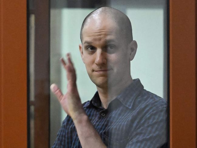 US journalist Evan Gershkovich gestures from inside a glass defendants' cage prior to a hearing in Yekaterinburg's Sverdlovsk Regional Court on Wednesday. Picture: Natalia Kolesnikova/AFP