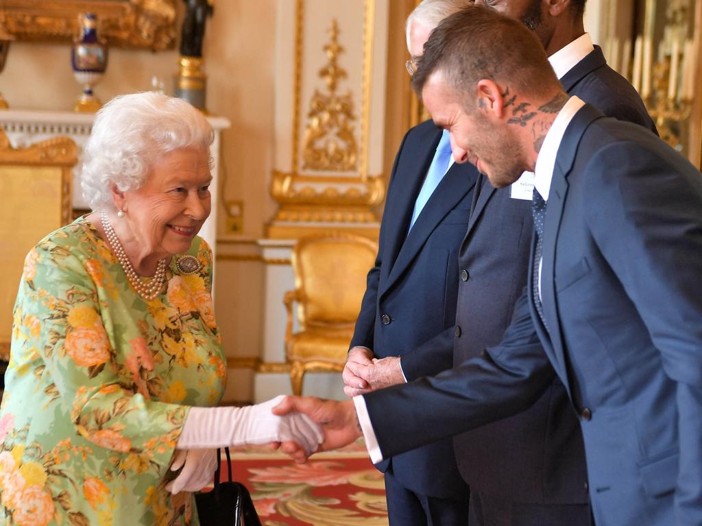 Archewell has hired the top executive for David Beckham (pictured with the Queen) for Harry and Meghan’s Netflix project. Picture: AFP