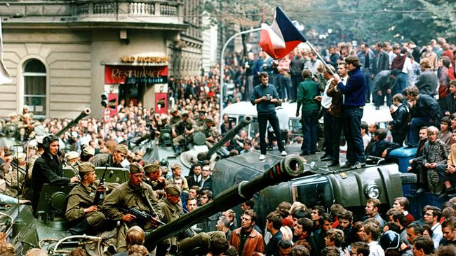 Czechs stand on an overturned truck as other Prague residents surround Soviet tanks in Prague in 1968 as the Soviet-led invasion crushed the so-called Prague Spring reform.