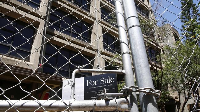 A for sale sign in the forecourt of the one of the building entrances, behind the wire fence. The Sirius Tower in The Rocks, 1 year after the last tenants were moved out of the Public housing tower. Picture: John Appleyard