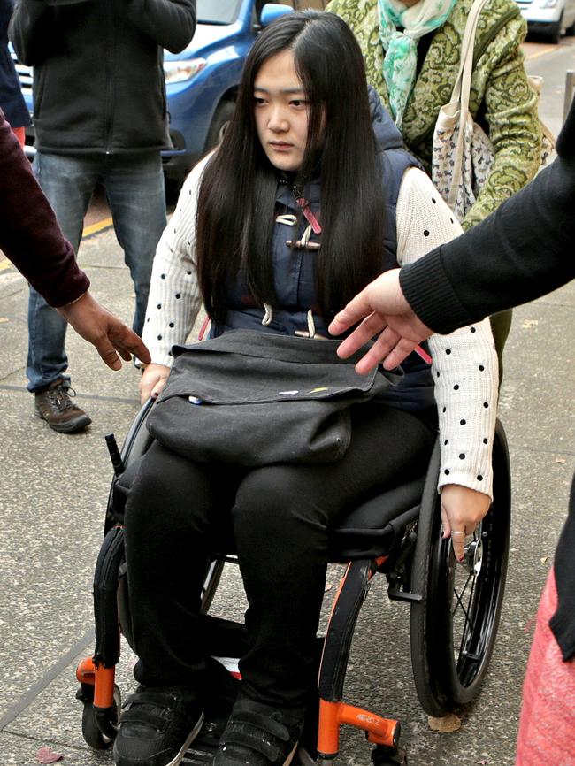 Yinuo ‘Ginger’ Jiang, 27, leaving court in a wheelchair, due to the injuries caused in the blaze. Picture: Stephen Cooper