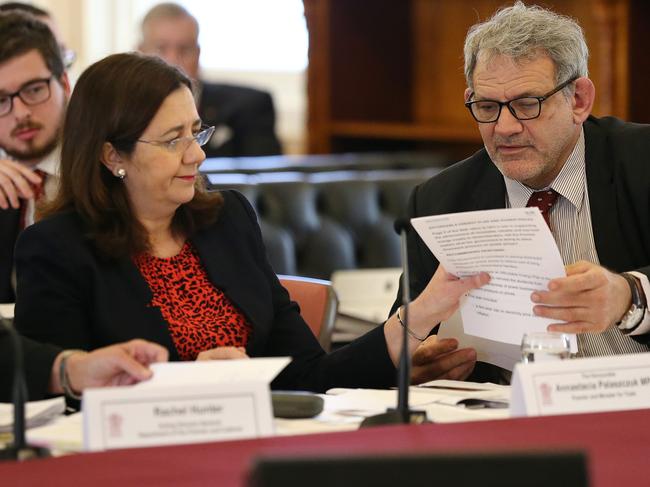 Premier Annastacia Palaszczuk speaks with chief-of-staff David Barbagallo during Estimates hearings.