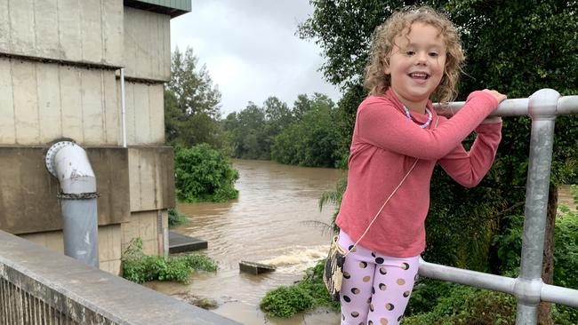 Lismore girl Asta Bruce-Allen, 4, checks the rising level of Wilson River at the Browns Creek Pump Station on Sunday.