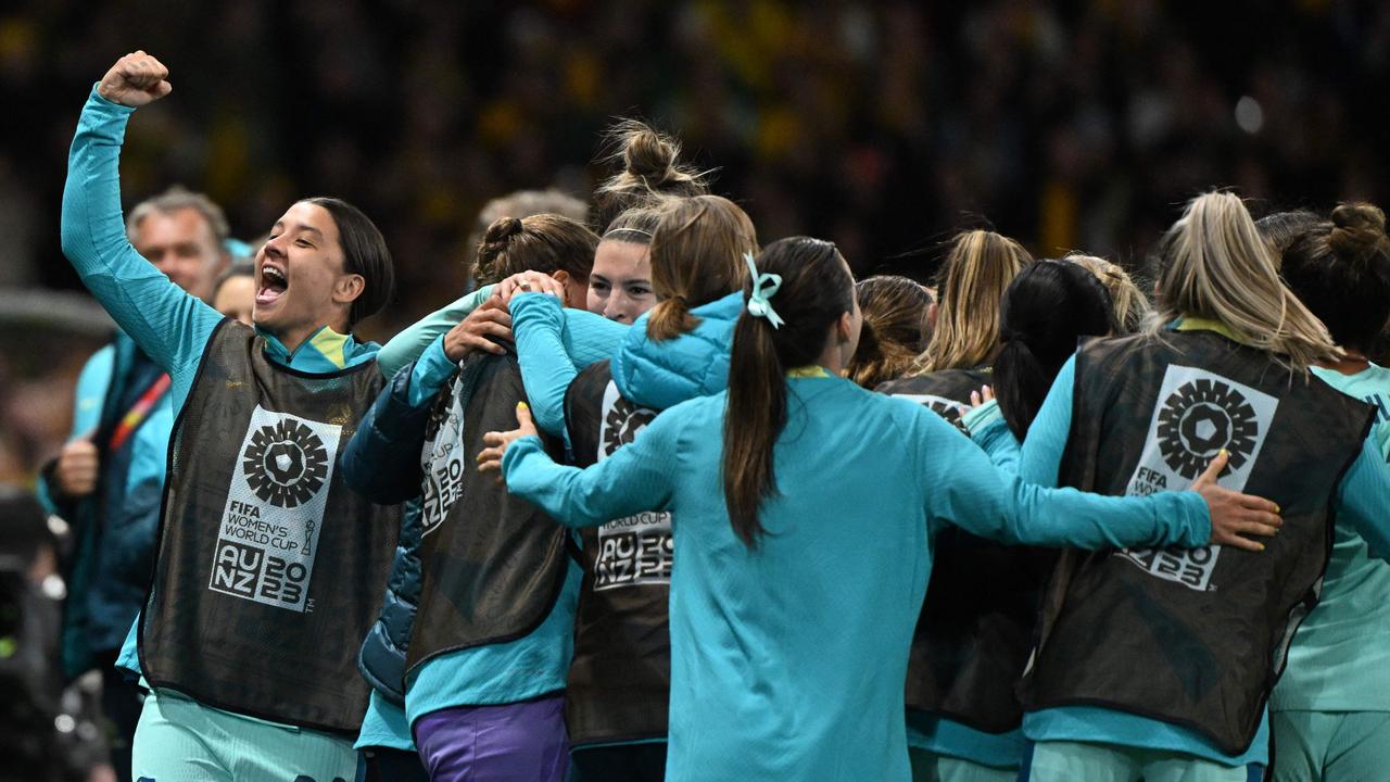 Sam Kerr (left) celebrates with her Matildas teammates after Australia's fourth goal against Canada. Picture: William West / AFP