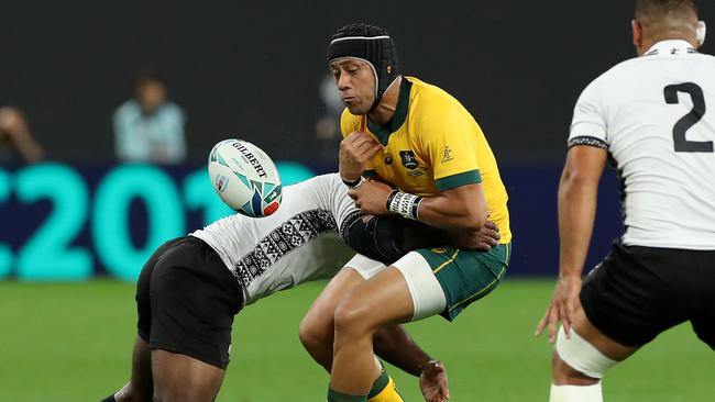 SAPPORO, JAPAN - SEPTEMBER 21: Christian Lealiifano of Australia drops the ball as he is tackled by Levani Botia of Fiji during the Rugby World Cup 2019 Group D game between Australia and Fiji at Sapporo Dome on September 21, 2019 in Sapporo, Hokkaido, Japan. (Photo by David Rogers/Getty Images)