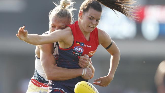 Erin Phillips of the Crows tackles Melbourne’s Lily Mithen.