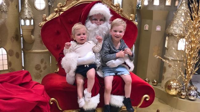 Beau, 14 months, and Teddy, 3, sit with Santa for the annual Christmas photo.