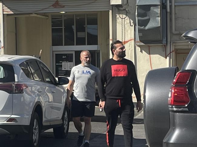 Walid Abdo (right) with an associate at the scene of the Phoenicia reception fire in Brunswick. Picture: Genevieve Holding