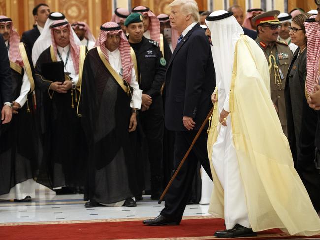 Saudi King Salman, second right, walks with Mr Trump at the summit. Picture: Evan Vucci/AP Photo