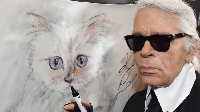 Lagerfeld with a sketch of his cat Choupette in 2015. Picture: AFP