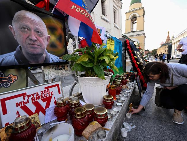 A woman lays a candle at a makeshift memorial for head of Wagner paramilitary group, Yevgeny Prigozhin in Moscow. Picture: Natalia Kolesnikova/AFP