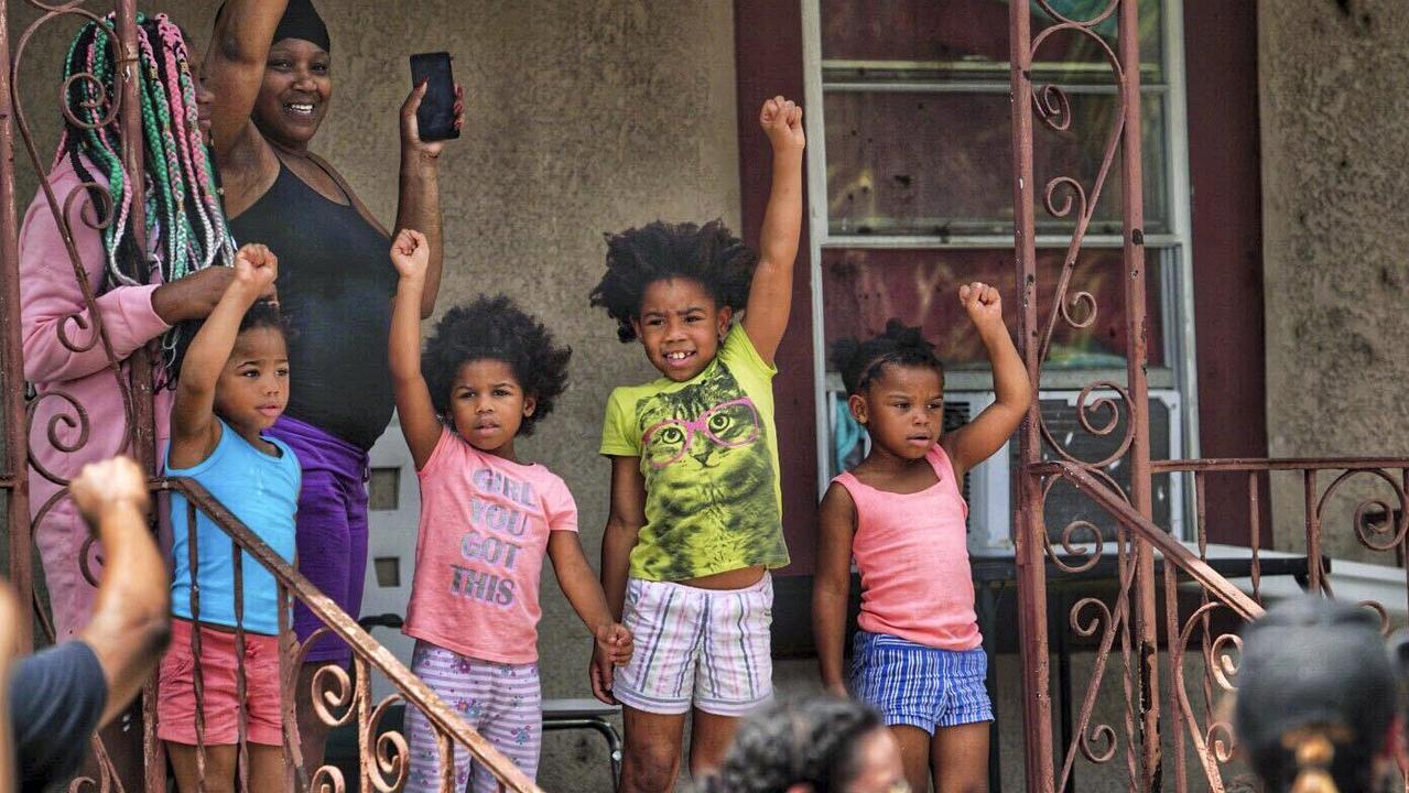 People show their support for a Black Lives Matter march as it passes in Tampa, Florida. Picture: Martha Ascencio-Rhine/Tampa Bay Times via AP