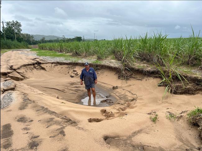 Cane grower Chris Butlers inspecting road damage at his Stone River farm north of Townsville. Picture: Lawrence Di Bella