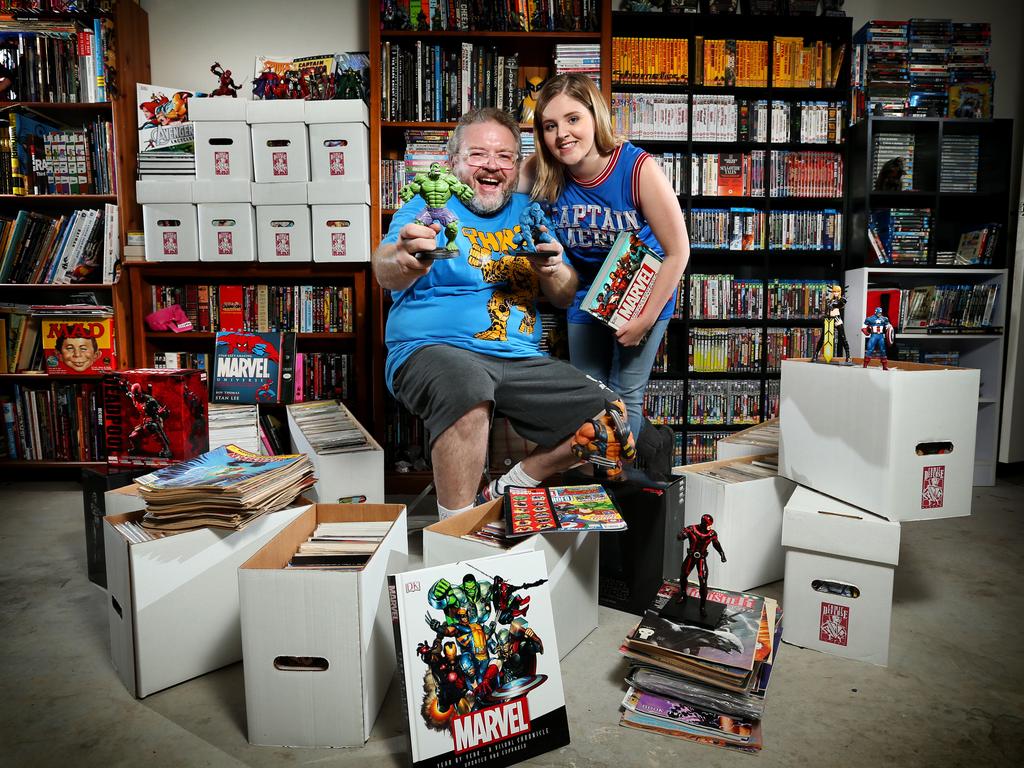 Pictured at his home in Gymea is comic fanatic Justin McNamara with his daughter Kirby (named after the author of the first Cptn America comic). Justin has been collecting comics and comic book related stuff since he was a little by. Picture: Richard Dobson