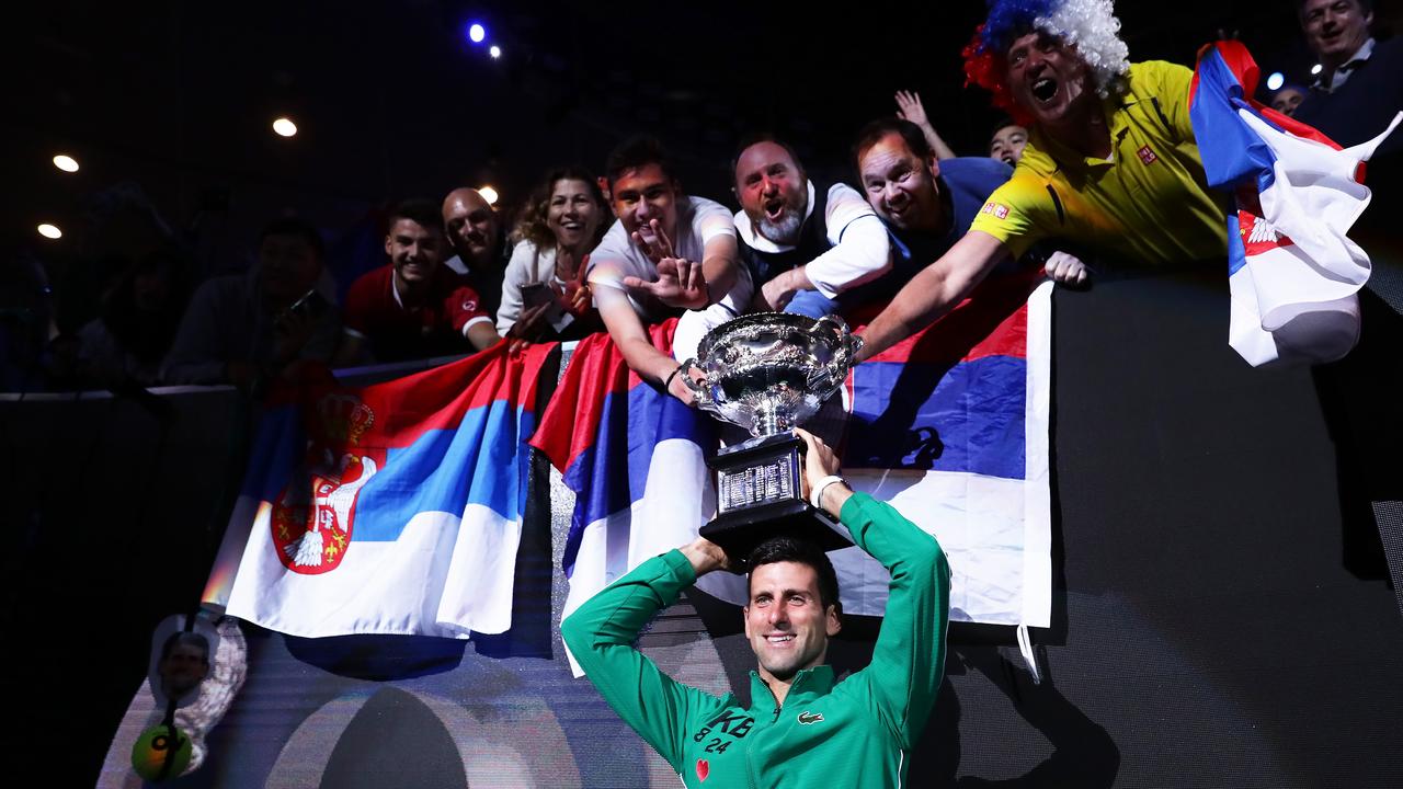 Novak Djokovic poses with fans.