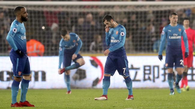 Arsenal's Henrikh Mkhitaryan, center, looks dejected after Arsenal concede.