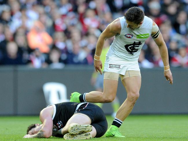 Marc Murphy gives Jake Carlisle after the Saint was felled by an accidental Levi Casboult hit to the groin. Picture: AAP