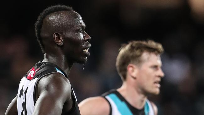 ADELAIDE, AUSTRALIA - SEPTEMBER 11: Tom Jonas of the Power and Aliir Aliir put their hands on their hips after another Bulldogs goal goes through during the 2021 AFL Second Preliminary Final match between the Port Adelaide Power and the Western Bulldogs at Adelaide Oval on September 11, 2021 in Adelaide, Australia. (Photo by Sarah Reed/AFL Photos via Getty Images)