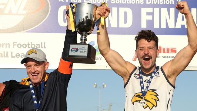 Whittlesea coach Blair Harvey and captain Riley Dyson lift the premiership cup. Picture: Hamish Blair