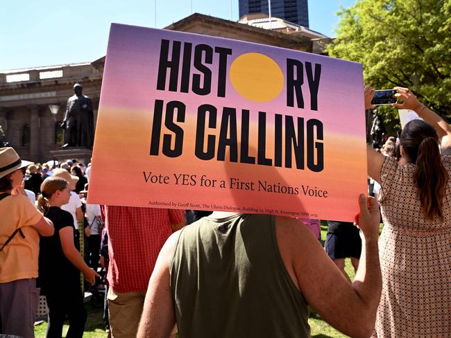 (FILES) A person holds a placard during a "Walk for Yes" rally for the upcoming "Voice" referendum in Sydney on September 17, 2023. A referendum aimed at elevating the rights of Indigenous Australians has instead triggered a torrent of racist slurs and abuse, with toxic debate spreading online and in the media. The October 14 vote will decide whether to finally recognise First Nation peoples in the constitution as Australia's first inhabitants. (Photo by William WEST / AFP)