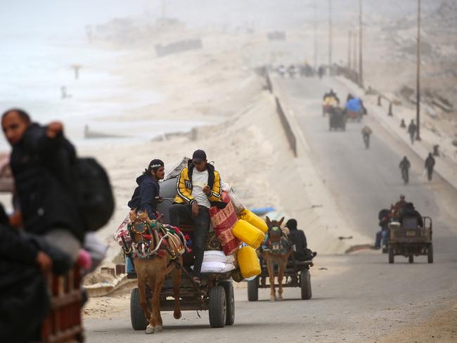 Palestinians ride vehicles with their belongings as they flee from the northern Gaza Strip via the Salah al-Din road near the Nusseirat refugee camp. Picture: AFP