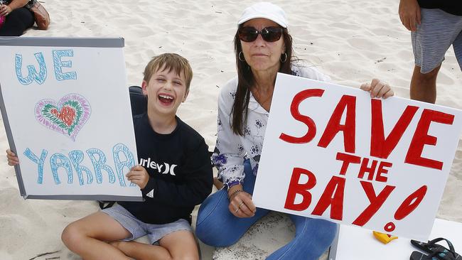 Micah Kilian, 7, from Matraville and Elisa Profino, from Chifley, join protesters on the beach. Picture: John Appleyard