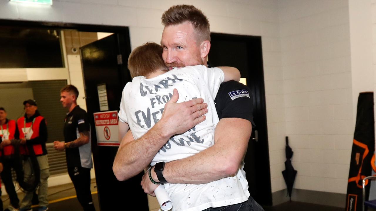 Nathan Buckley celebrates with son Jett after upsetting Richmond in the 2018 preliminary final.