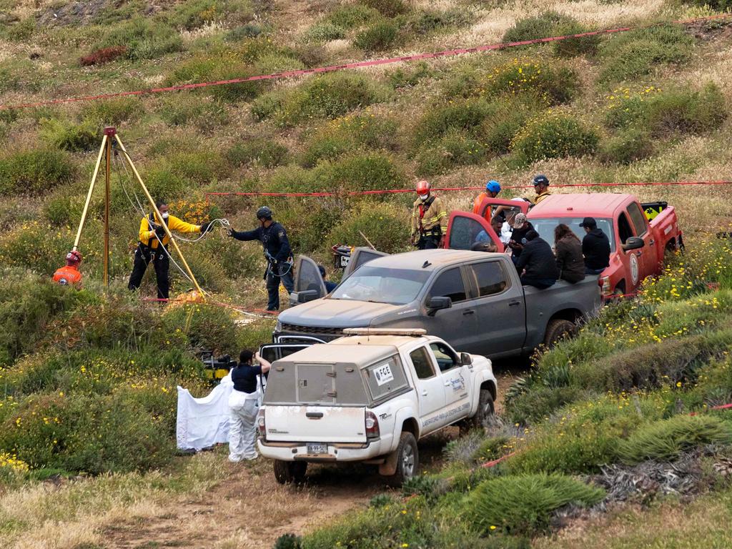 Rescue workers, forensics, and prosecutors work in a well where the remains of Australian brothers Jake and Callum Robinson and their American friend Jack Carter Rhoad were found, near La Bocana Beach in Ensenada, Mexico. Picture: Guillermo Arias/AFP