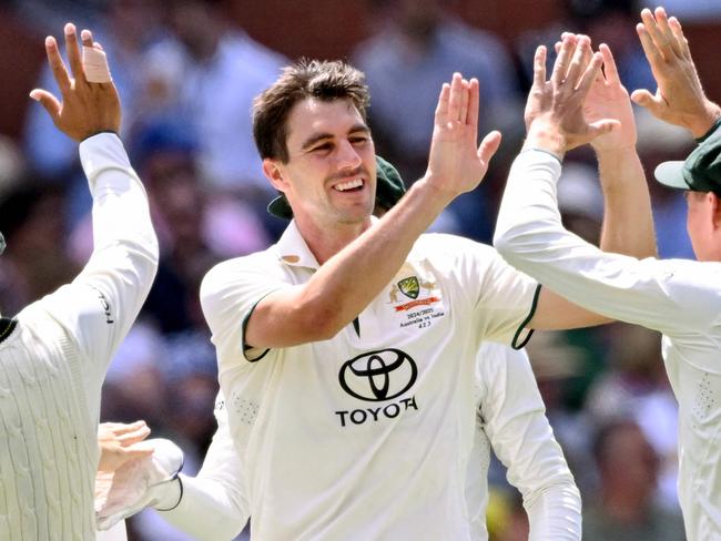 Australia's Pat Cummins celebrates taking a wicket on the third day of the second cricket Test match between Australia and India at the Adelaide Oval in Adelaide on December 8, 2024. (Photo by William WEST / AFP) / -- IMAGE RESTRICTED TO EDITORIAL USE - STRICTLY NO COMMERCIAL USE --