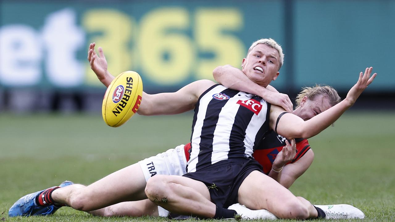 MELBOURNE, AUSTRALIA - JULY 24: Mason Redman of the Bombers tackles Jack Ginnivan of the Magpies during the round 19 AFL match between the Collingwood Magpies and the Essendon Bombers at Melbourne Cricket Ground on July 24, 2022 in Melbourne, Australia. (Photo by Darrian Traynor/Getty Images)